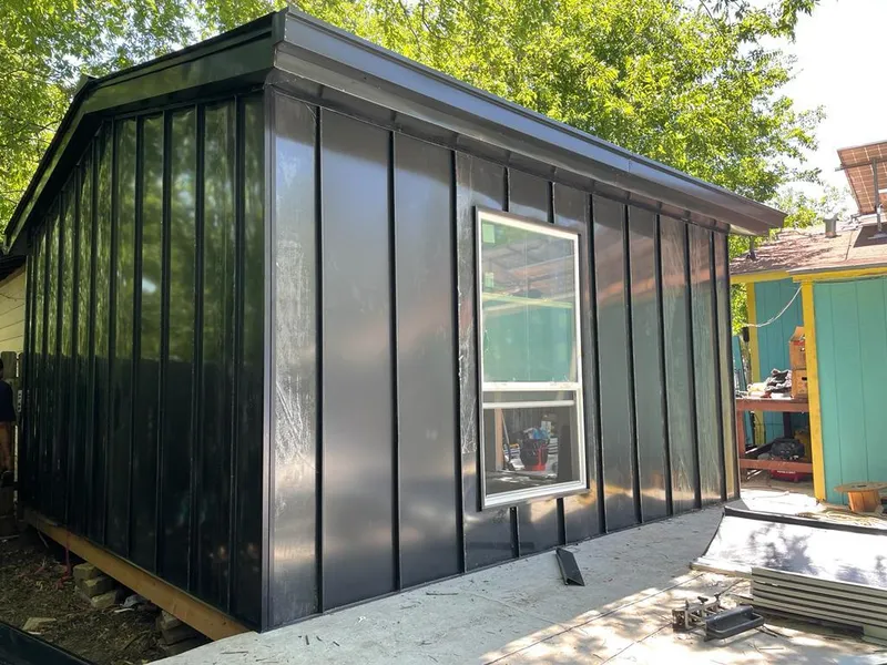 Black standing seam metal wall panels for Roof Inspection in San Juan